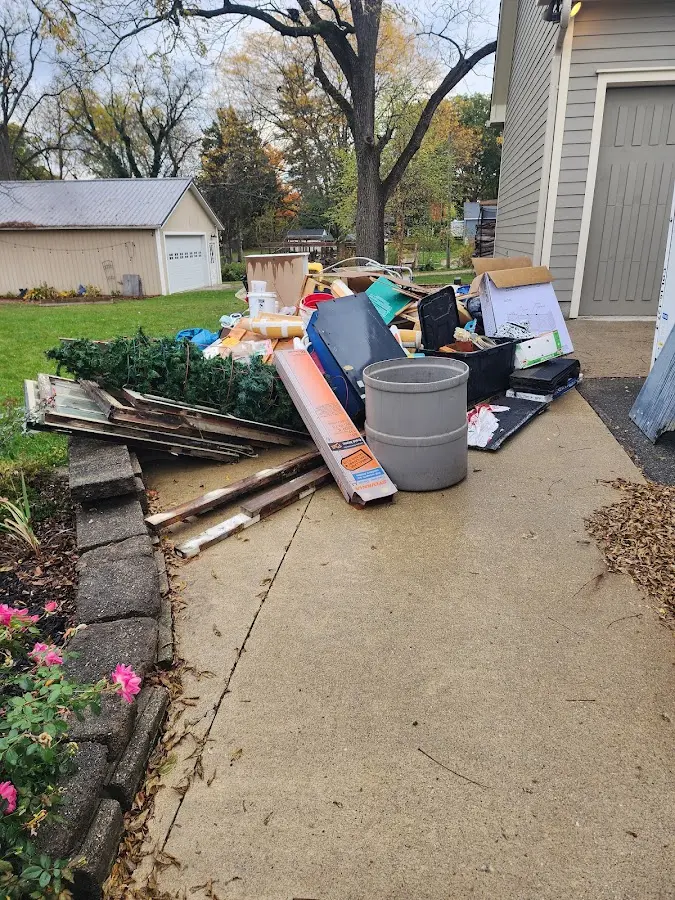 Dumpster being loaded with debris for Estate Cleanout Dumpster Rental in Straban